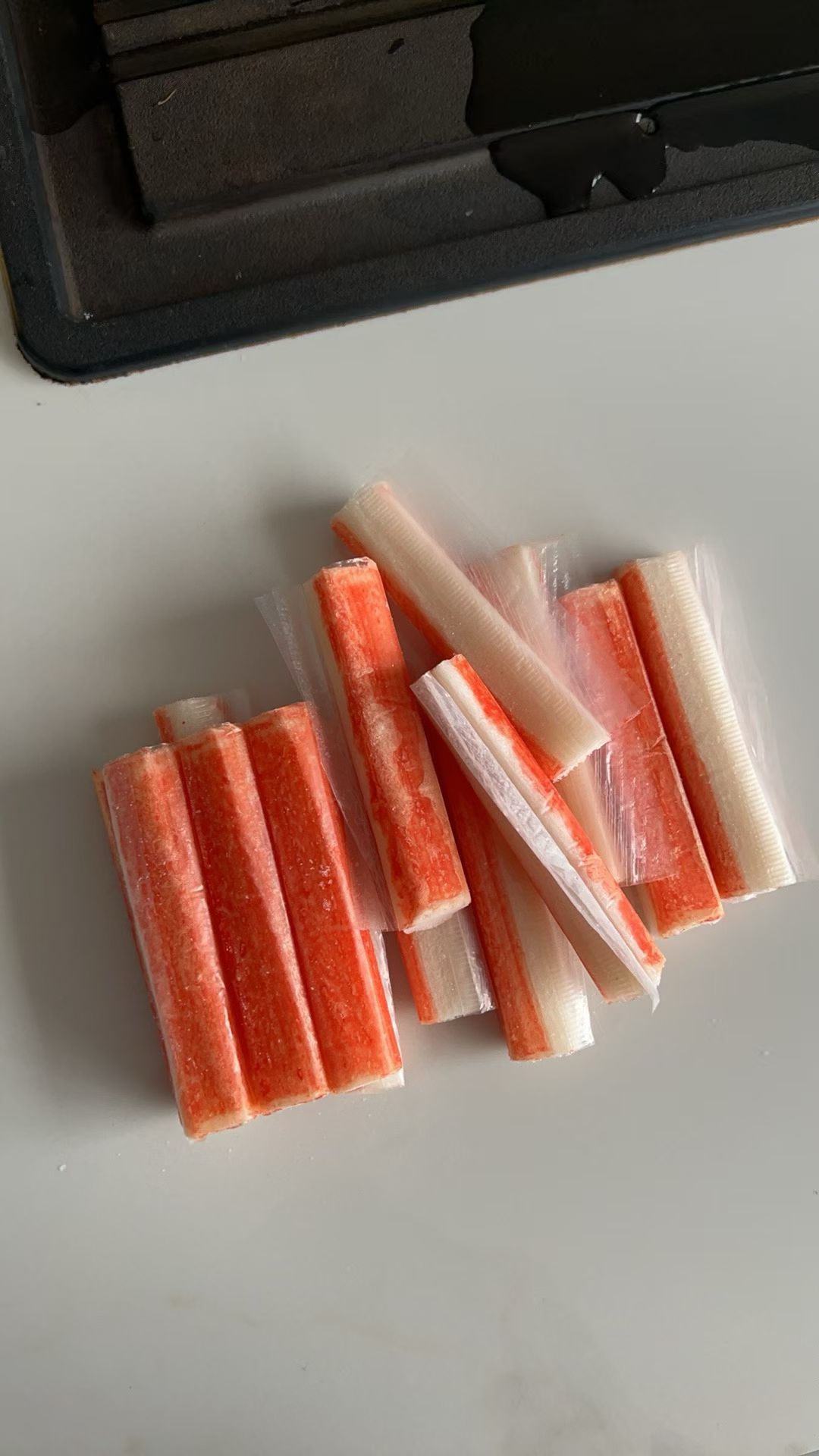 A group of orange and white crab stick product samples